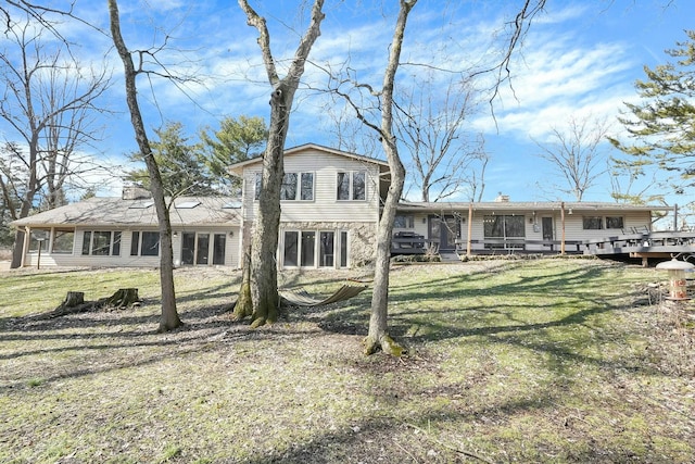 rear view of property with a lawn