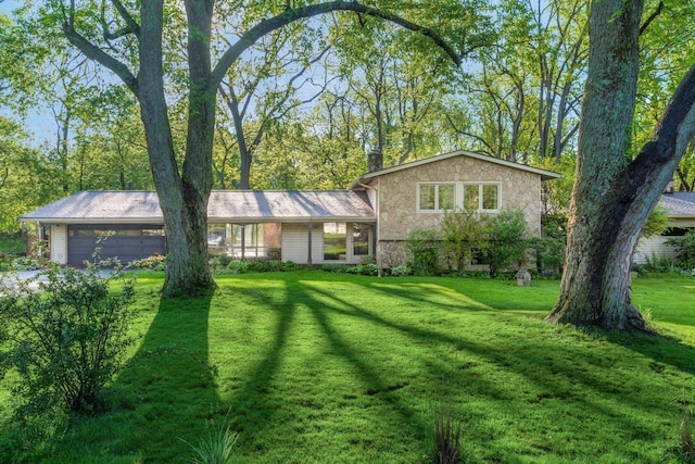 1750 Stoneybrook Way, Blacklick, OH 43004 - split level home with an attached garage, a front yard, stone siding, and a chimney