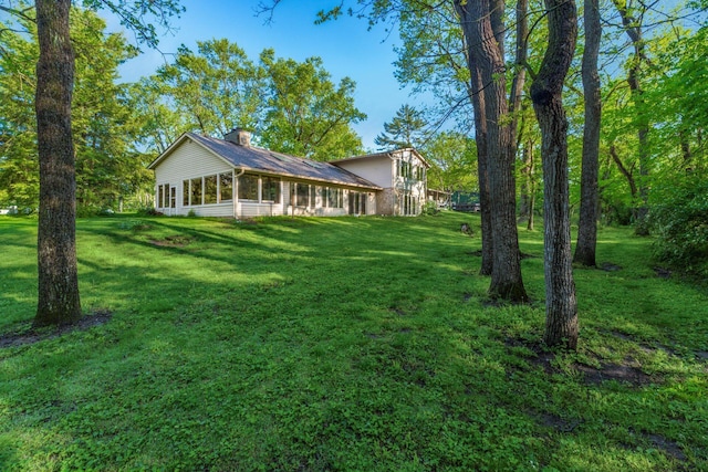 1750 Stoneybrook Way, Blacklick, OH 43004 - view of front facade with a chimney, a front yard, and a sunroom