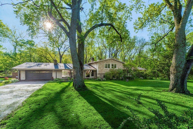 1750 Stoneybrook Way, Blacklick, OH 43004 - tri-level home featuring a garage, a front yard, driveway, a chimney, and brick siding