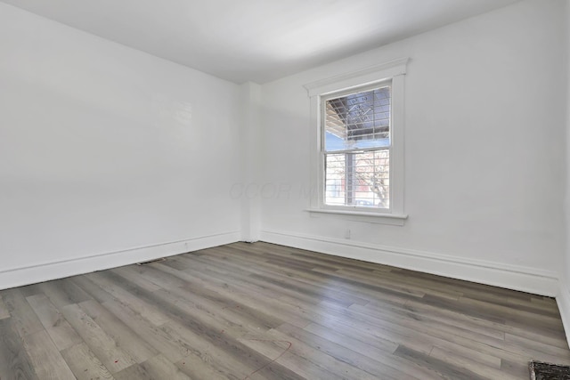 unfurnished room with wood-type flooring