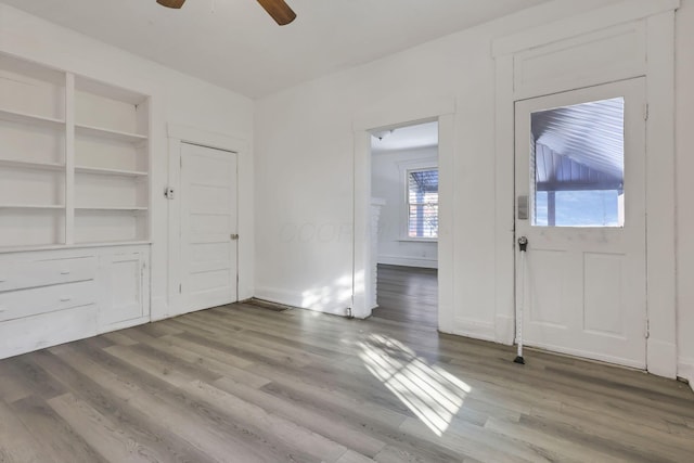 entrance foyer with ceiling fan and wood-type flooring