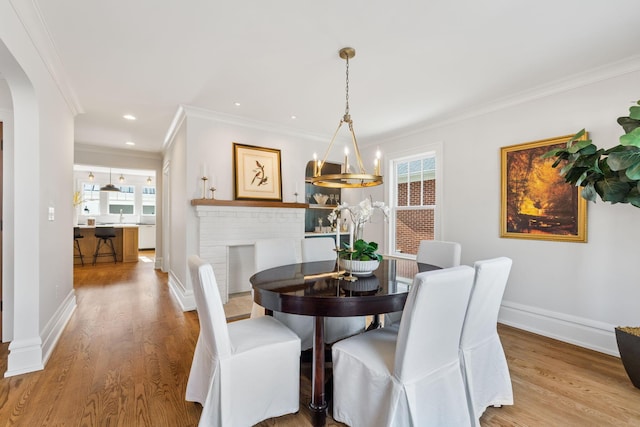 dining area featuring light hardwood / wood-style flooring and ornamental molding