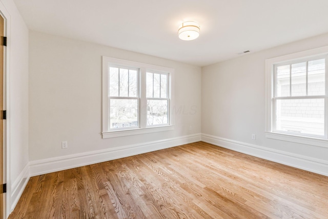 spare room with hardwood / wood-style floors