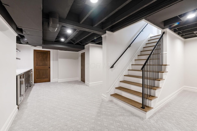 basement featuring light carpet