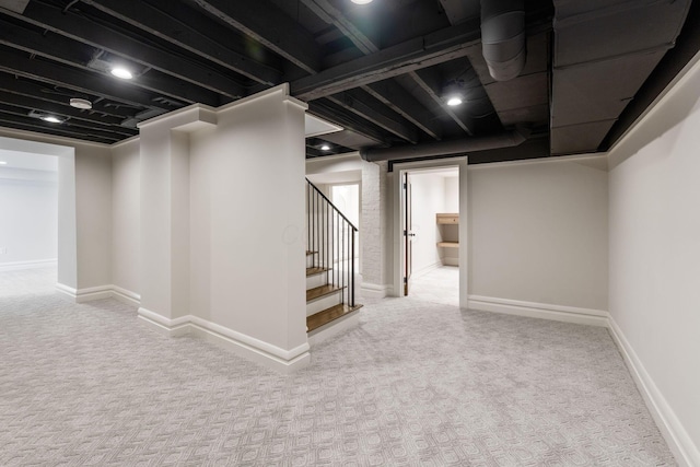 basement featuring light carpet