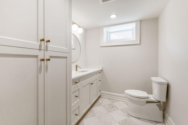 bathroom featuring vanity and toilet