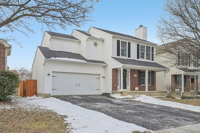 view of front of property featuring a garage and a porch