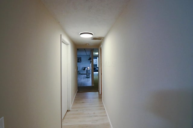 corridor featuring light hardwood / wood-style floors