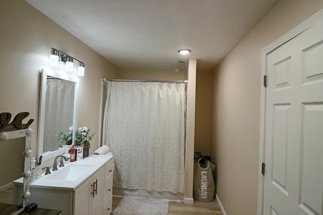 bathroom featuring vanity and hardwood / wood-style floors