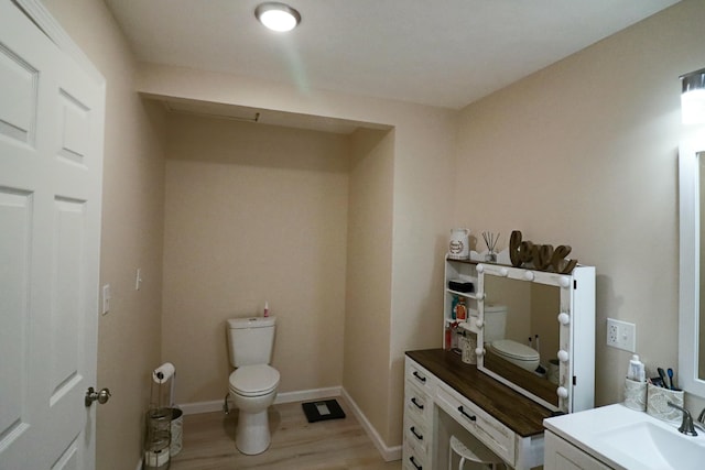 bathroom featuring vanity, toilet, and wood-type flooring