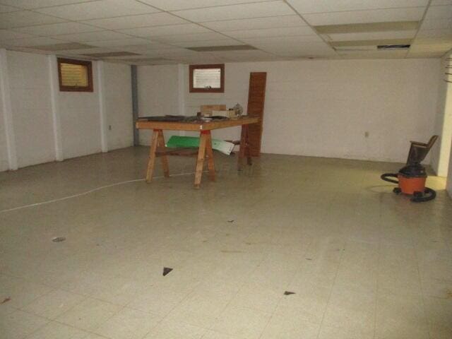 basement featuring a paneled ceiling