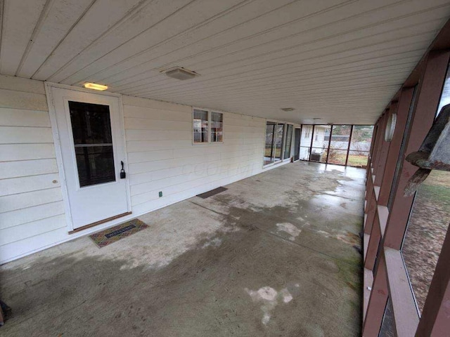 unfurnished sunroom with wood ceiling