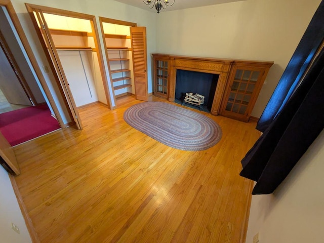 living room with a chandelier and light wood-type flooring