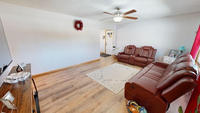 living room featuring hardwood / wood-style floors and ceiling fan