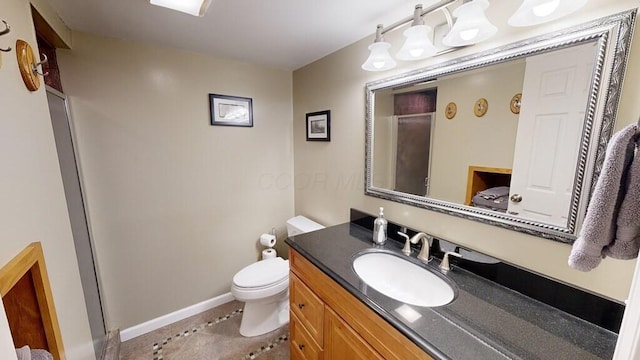 bathroom with tile patterned flooring, vanity, and toilet