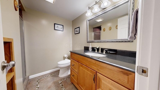 bathroom featuring vanity, tile patterned flooring, and toilet