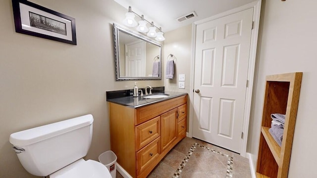 bathroom with vanity, tile patterned floors, and toilet