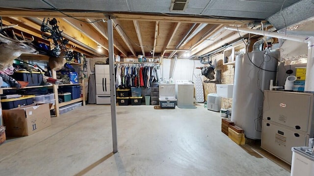 basement with gas water heater and washer and dryer