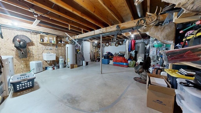 basement featuring sink and water heater