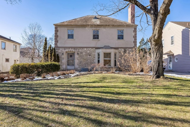 rear view of house featuring a lawn