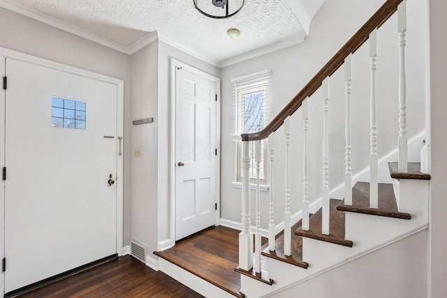 entryway featuring crown molding, dark hardwood / wood-style floors, and a textured ceiling