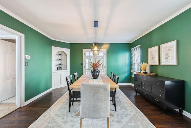 dining room with ornamental molding and dark hardwood / wood-style floors