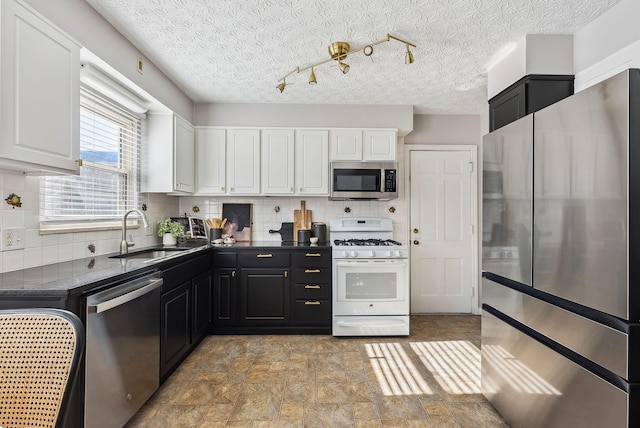 kitchen with backsplash, stainless steel appliances, sink, and white cabinets