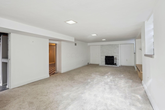 unfurnished living room featuring light colored carpet and a fireplace