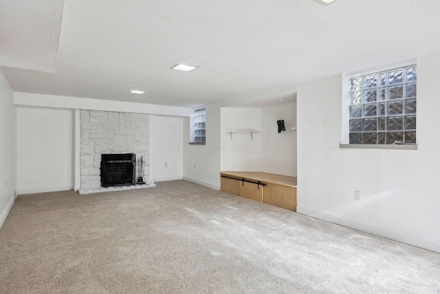 unfurnished living room with carpet flooring and a fireplace