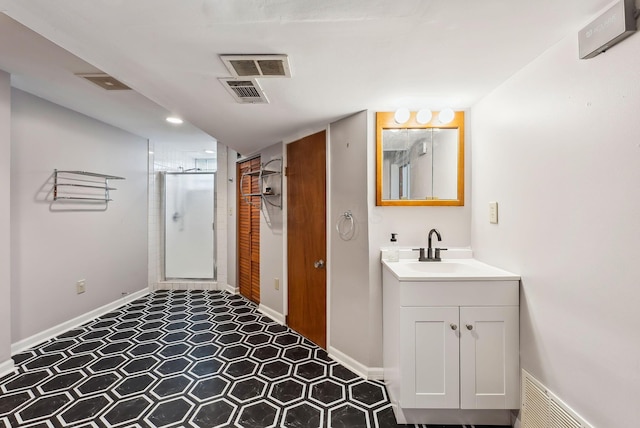 bathroom featuring vanity and a shower with door