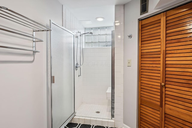 bathroom with a shower with shower door