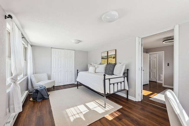 bedroom featuring dark wood-type flooring and a closet