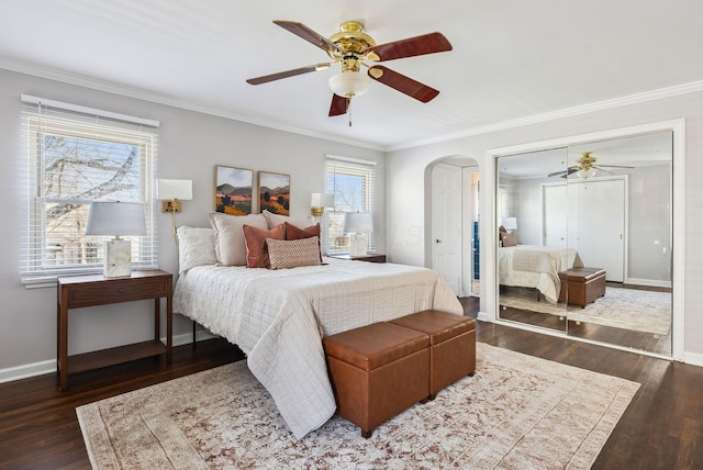 bedroom featuring multiple windows, dark hardwood / wood-style flooring, and ceiling fan