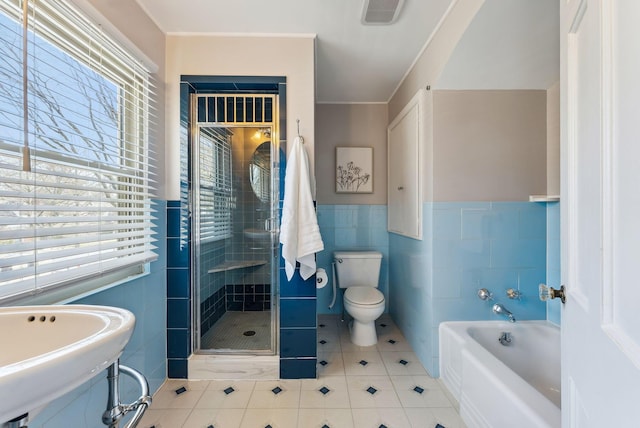 full bathroom with toilet, sink, tile walls, independent shower and bath, and tile patterned flooring