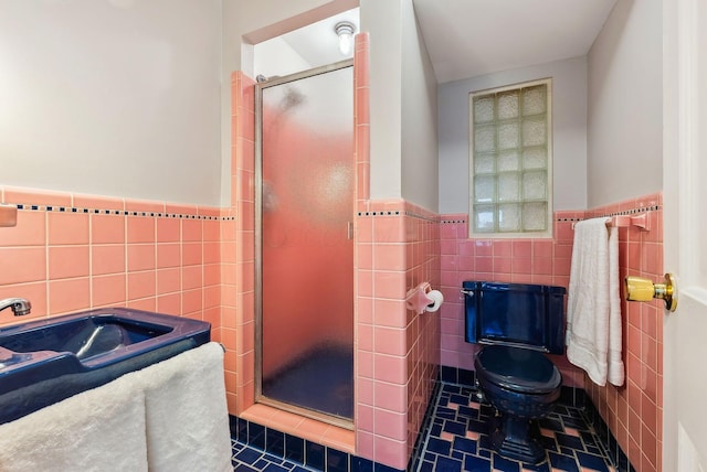 bathroom with tile patterned flooring, toilet, tile walls, and walk in shower