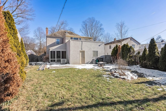 back of property with a patio, a yard, central AC, and an outdoor fire pit