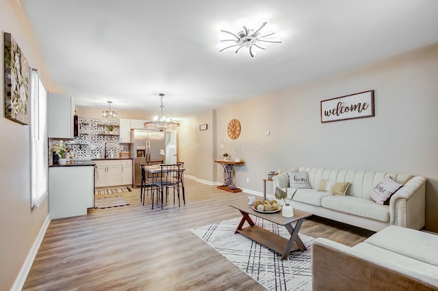 living room featuring light hardwood / wood-style floors and a chandelier