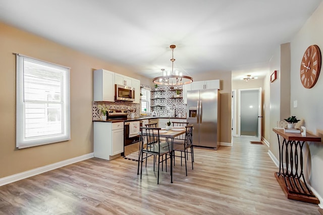 dining room with an inviting chandelier and light hardwood / wood-style floors