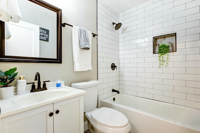 full bathroom featuring vanity, toilet, and tiled shower / bath combo