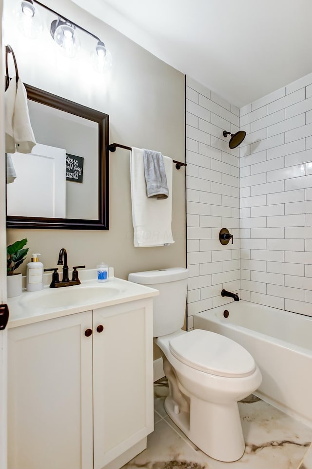 full bathroom featuring tiled shower / bath, vanity, toilet, and tile patterned floors