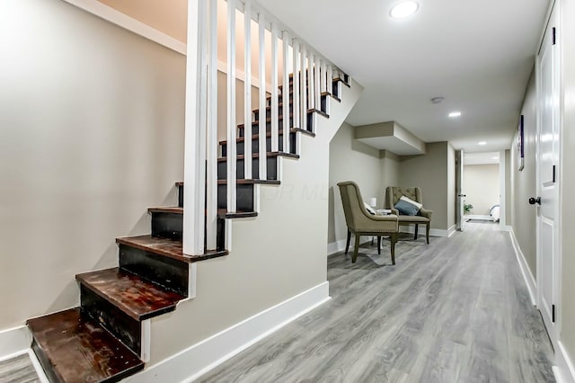 stairs featuring hardwood / wood-style floors