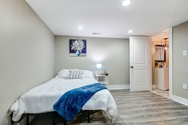 bedroom with hardwood / wood-style flooring