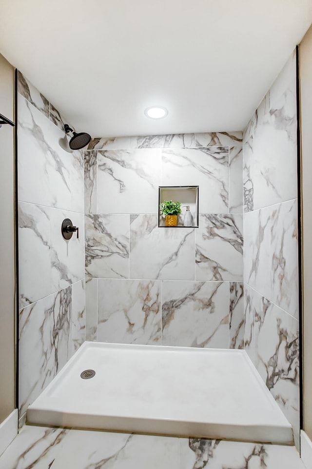 bathroom with tiled shower