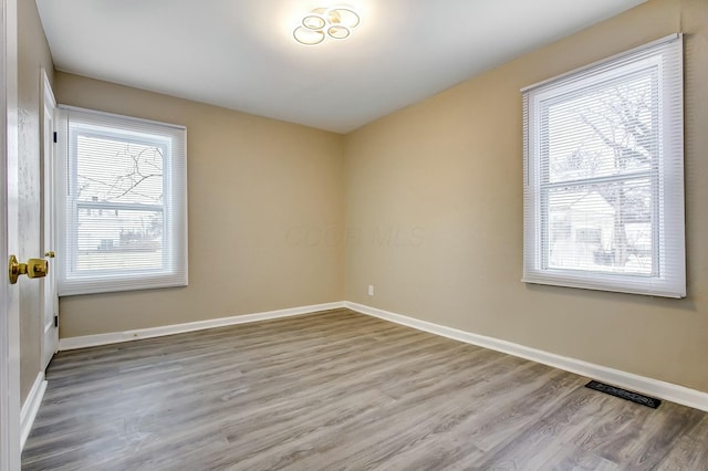 empty room with wood-type flooring