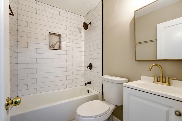 full bathroom featuring tiled shower / bath, vanity, and toilet