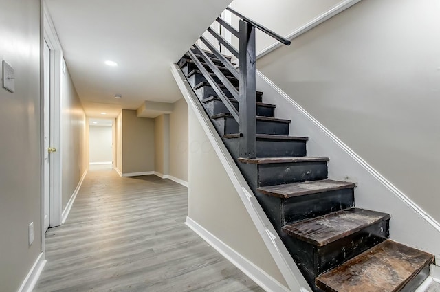 stairs featuring hardwood / wood-style floors