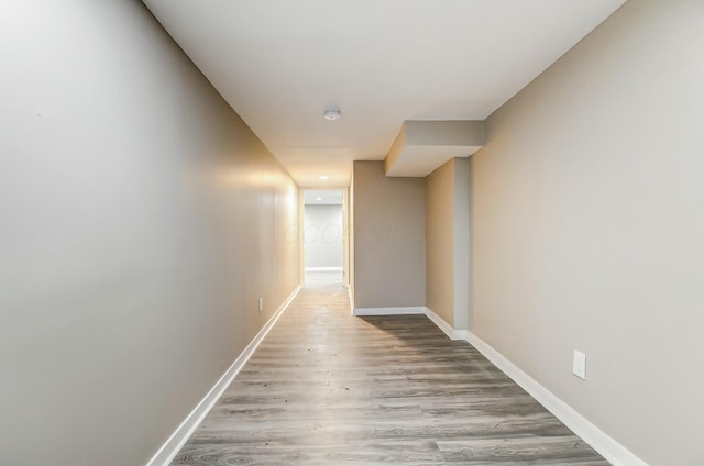 hallway with light hardwood / wood-style floors