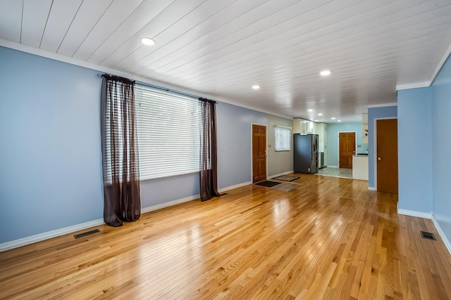 unfurnished living room with crown molding, wood ceiling, and light wood-type flooring