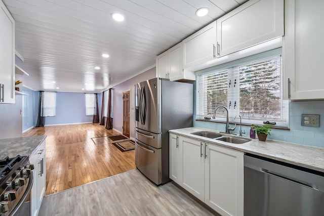 kitchen with light stone counters, stainless steel appliances, and white cabinets